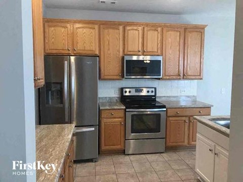 a kitchen with stainless steel appliances and wooden cabinets