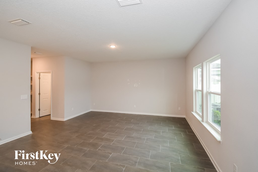 the living room of an empty house with a large window