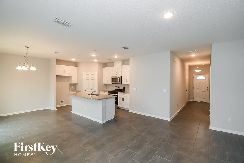 a large kitchen with white cabinets and a white counter top