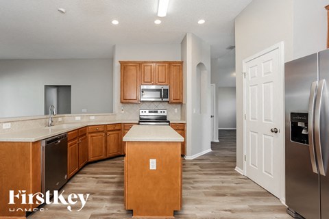 A kitchen with wooden cabinets and stainless steel appliances.