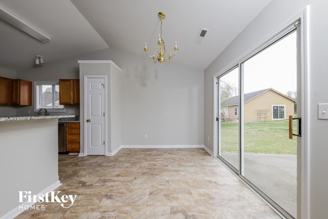 a kitchen and living room with a large sliding glass door