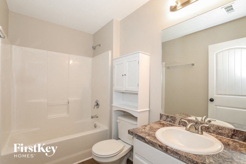a bathroom with a sink and a toilet and a shower