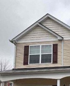 A two-story house with a garage and a truck parked in front.