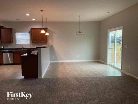 A kitchen area with a counter and cabinets is shown in the image.