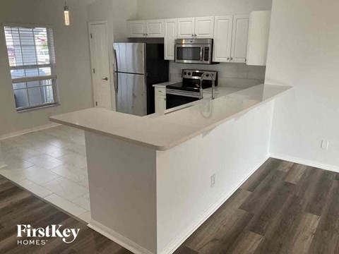 a kitchen with a counter top and a refrigerator