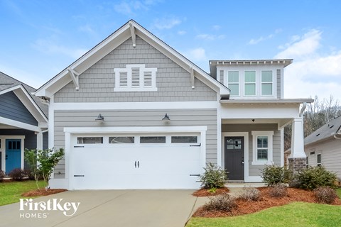 A two-story house with a garage is for sale by FirstKey Homes.