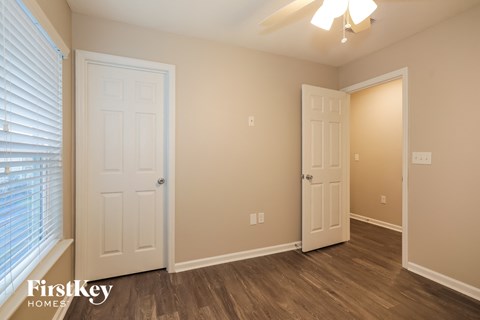 a bedroom with two doors and a door to a closet