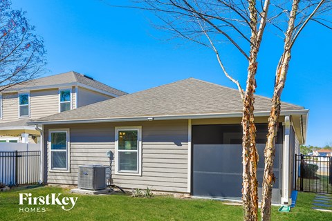 the front of a house with two birch trees