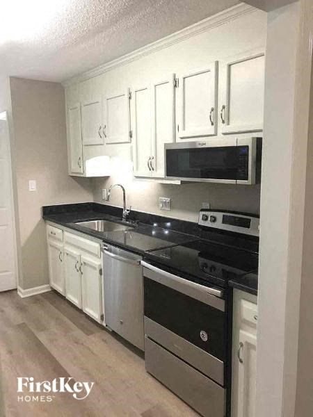 a kitchen with a stove and a microwave