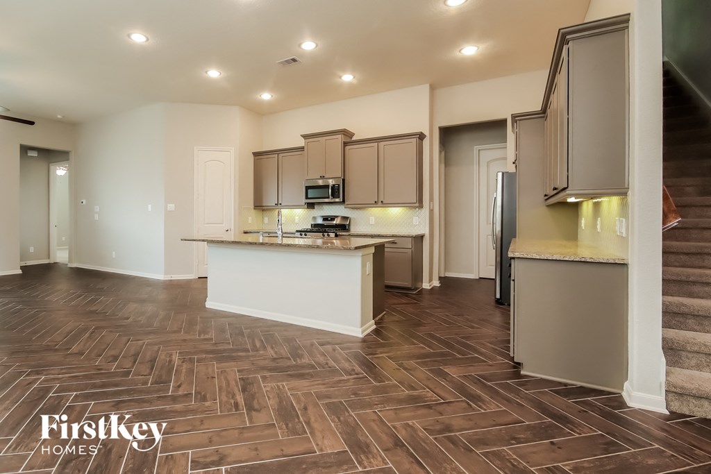 the kitchen is open to the living room and dining room