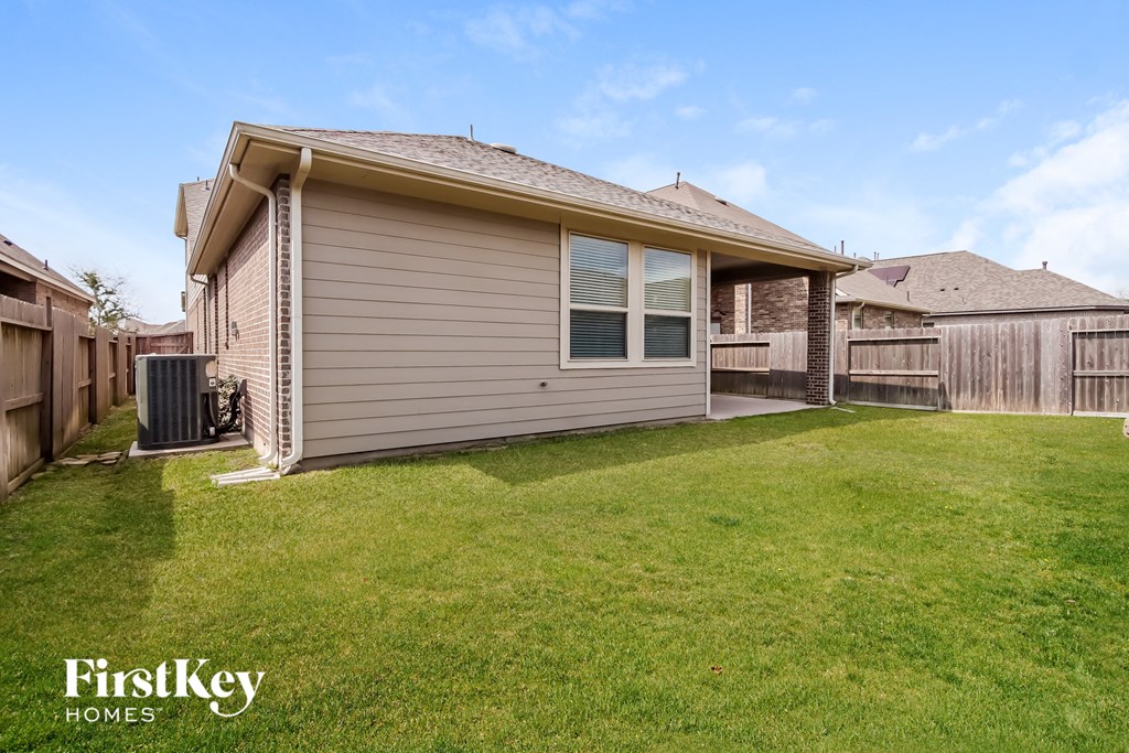 a small house with a yard and a fence