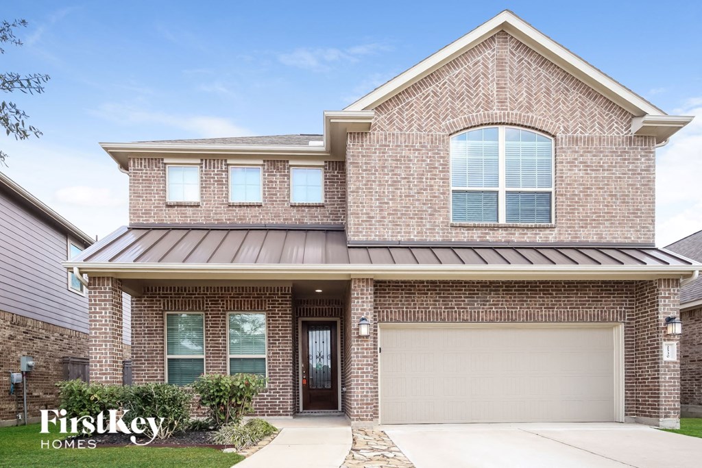 a brick house with a white garage door