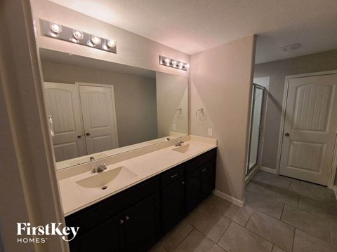 a bathroom with two sinks and a large mirror