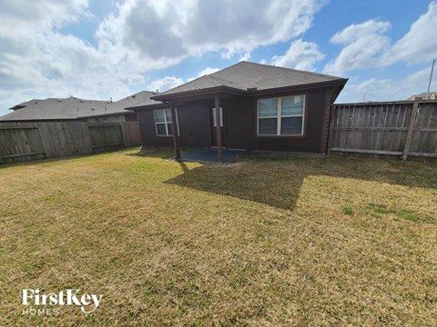 a backyard with a house and a yard with grass