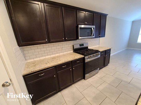 a kitchen with black cabinets and a counter top