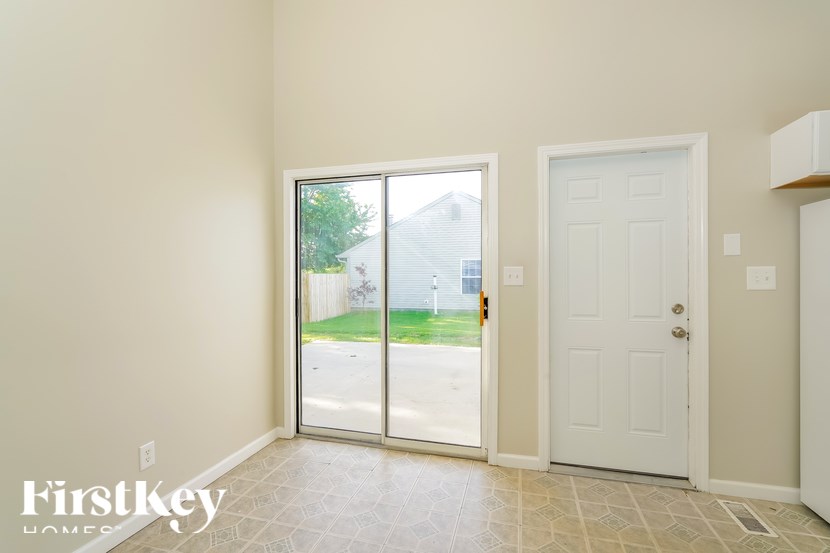 A room with a sliding glass door leading to a driveway.