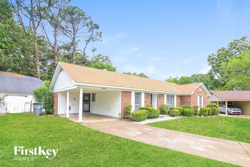 A house with a brown roof and a garage door is for sale.