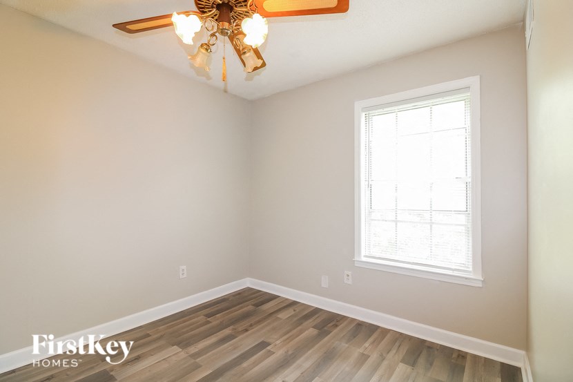 A room with a window and a chandelier.