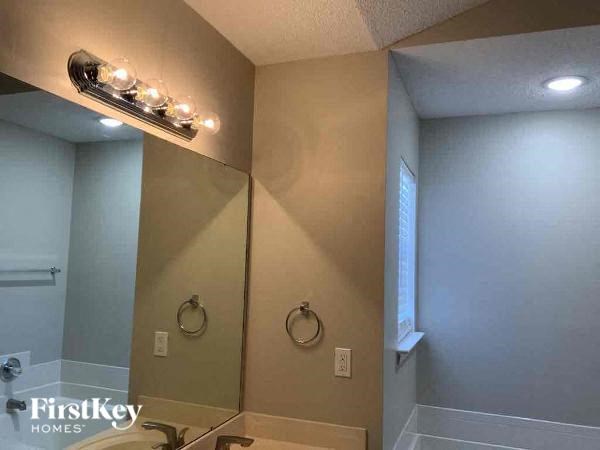 a bathroom with a large mirror and a sink