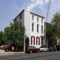 a white building with cars parked in front of it