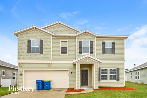 a beige house with a blue sky in the background