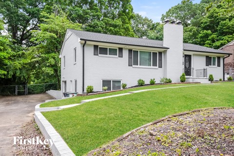 a white house with a yard and a sidewalk