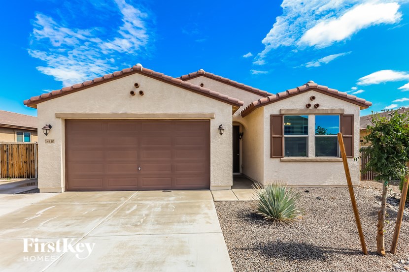 A house with a brown garage door is for sale.