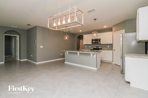 A kitchen with a white counter and a grey wall.