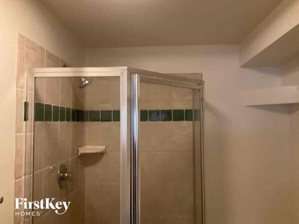 a shower in a small bathroom with a glass door