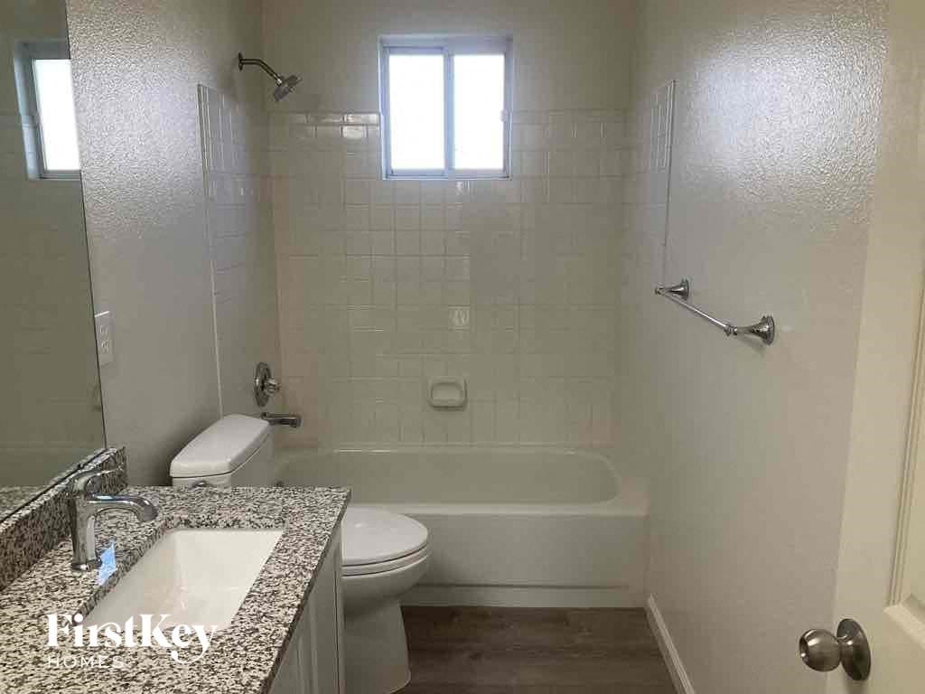 a small bathroom with a toilet and a tub and a sink