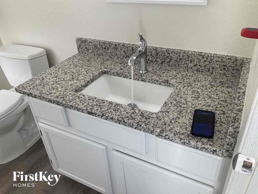 an image of a kitchen counter with a sink and a faucet