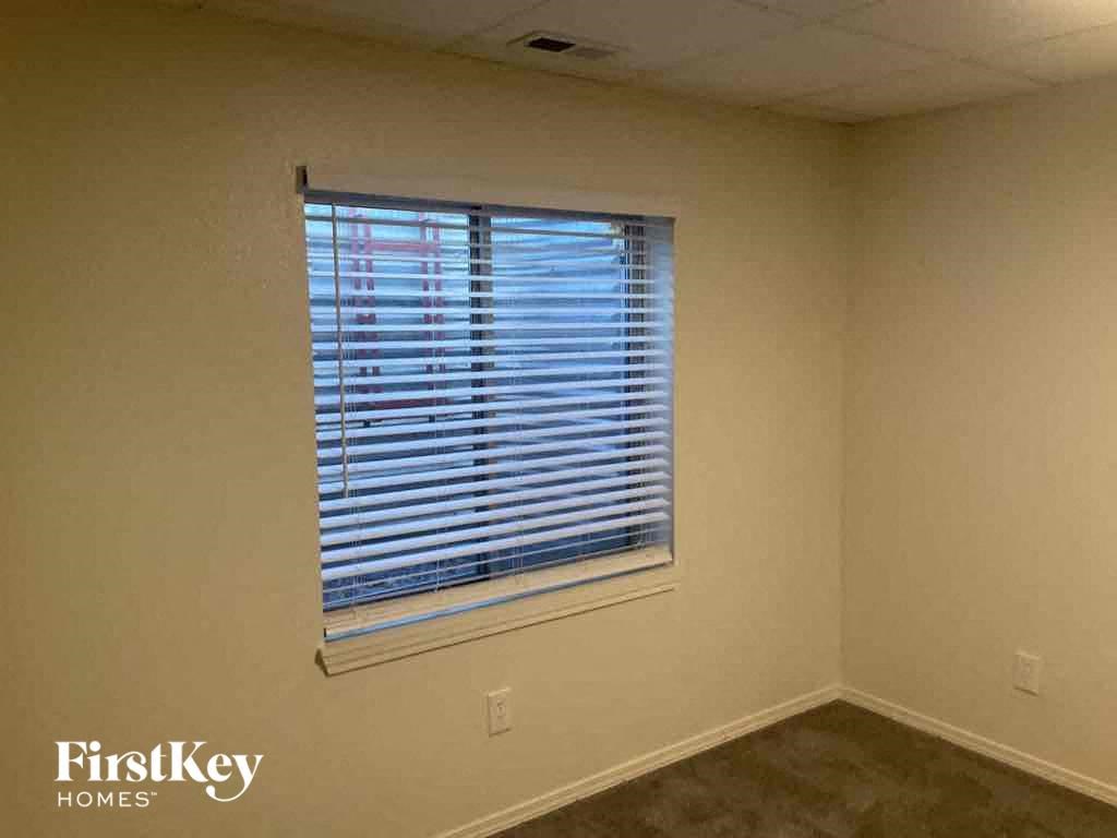 a room with a window with blinds in it