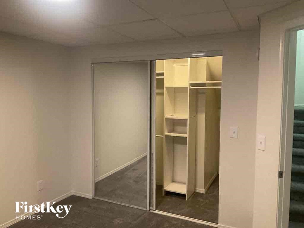 an empty closet in a room with mirrored doors