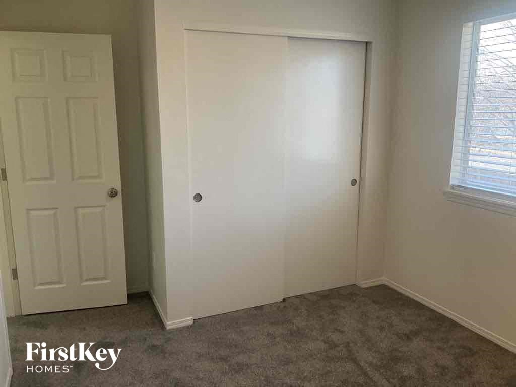 a room with a closet and a window and a door