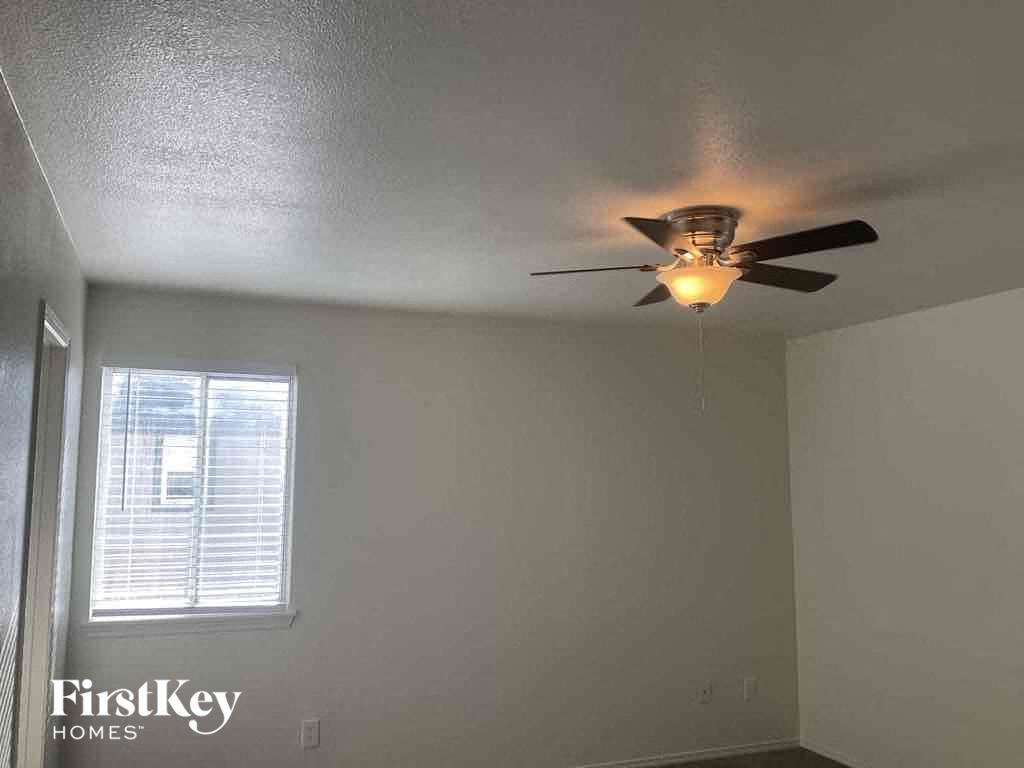 a ceiling fan in a room with a window