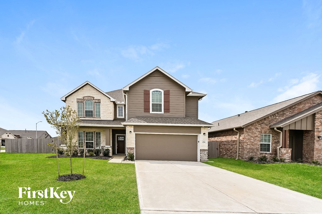 a house with a driveway and a garage door