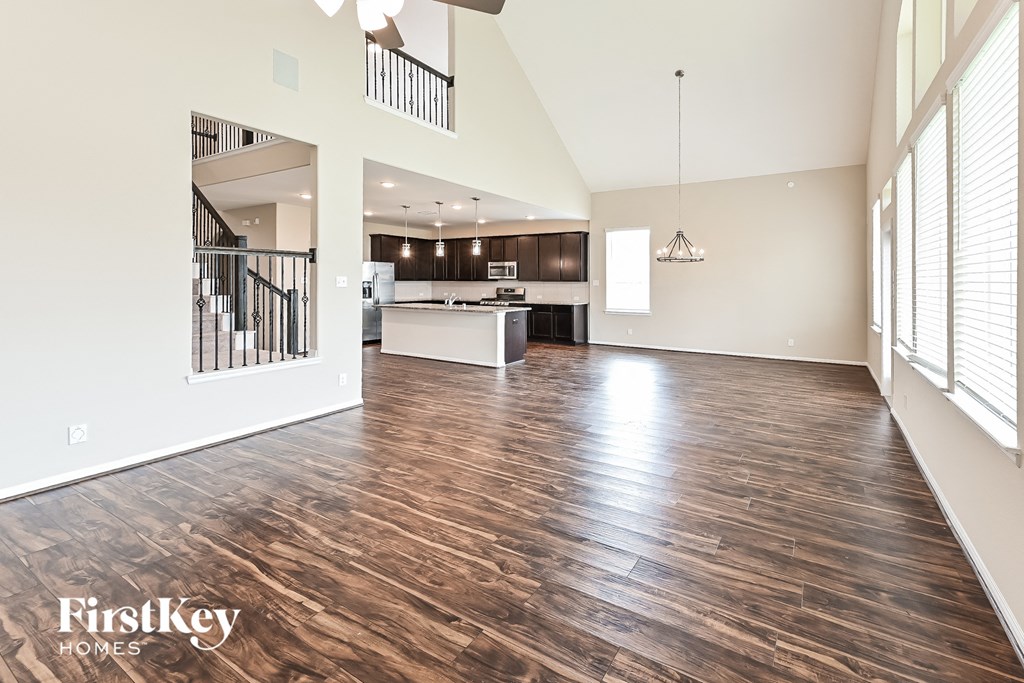 an open living room and kitchen with wood flooring