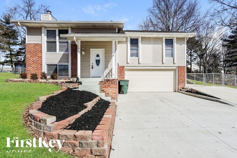 A house with a white door and a brick wall.