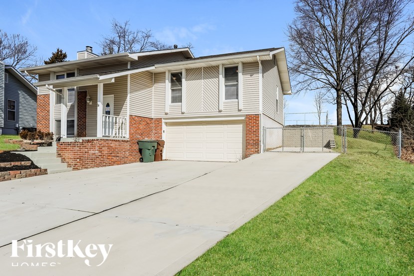 A house with a grey roof and a white garage door.
