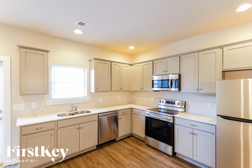 A kitchen with white cabinets and stainless steel appliances.