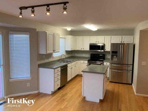 a kitchen with stainless steel appliances and white cabinets