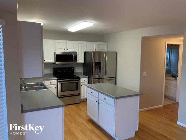 a kitchen with stainless steel appliances and white cabinets