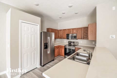 a kitchen with stainless steel appliances and wooden cabinets