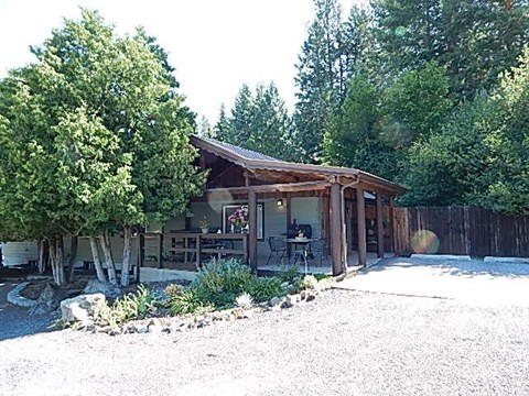 a small cabin with a patio and trees
