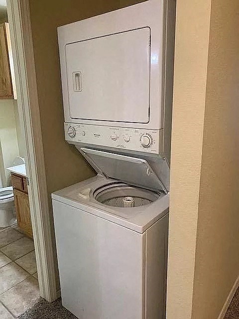 a washing machine and a toilet in a small bathroom