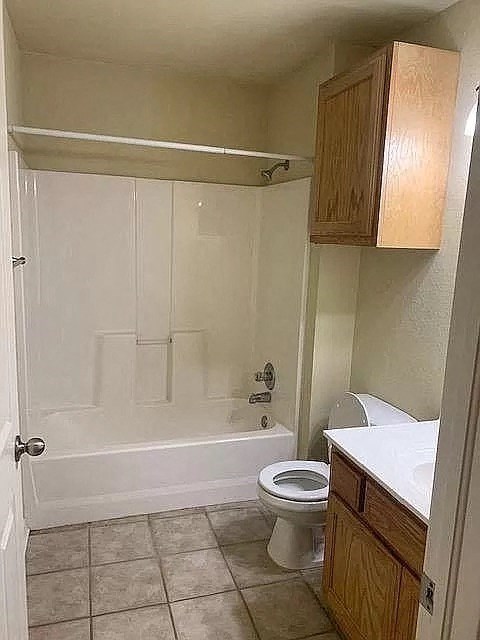 a bathroom with a toilet and a tub and a sink