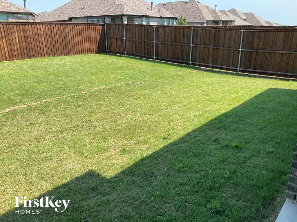 a fisheye view of a backyard with a wooden fence