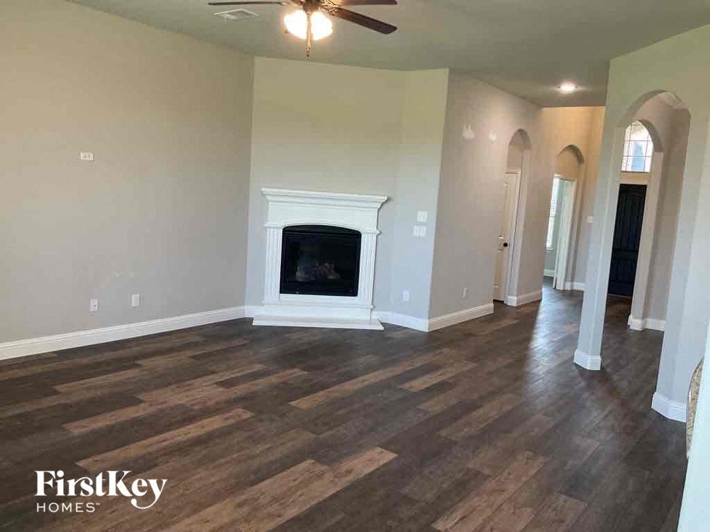 a living room with a fireplace and wooden floors