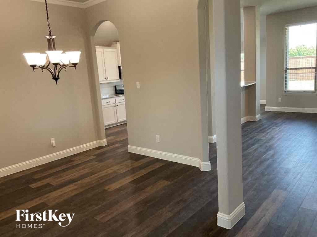 an empty living room and dining room with hardwood flooring
