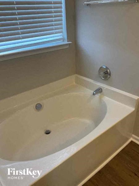 a bath tub in a bathroom next to a window